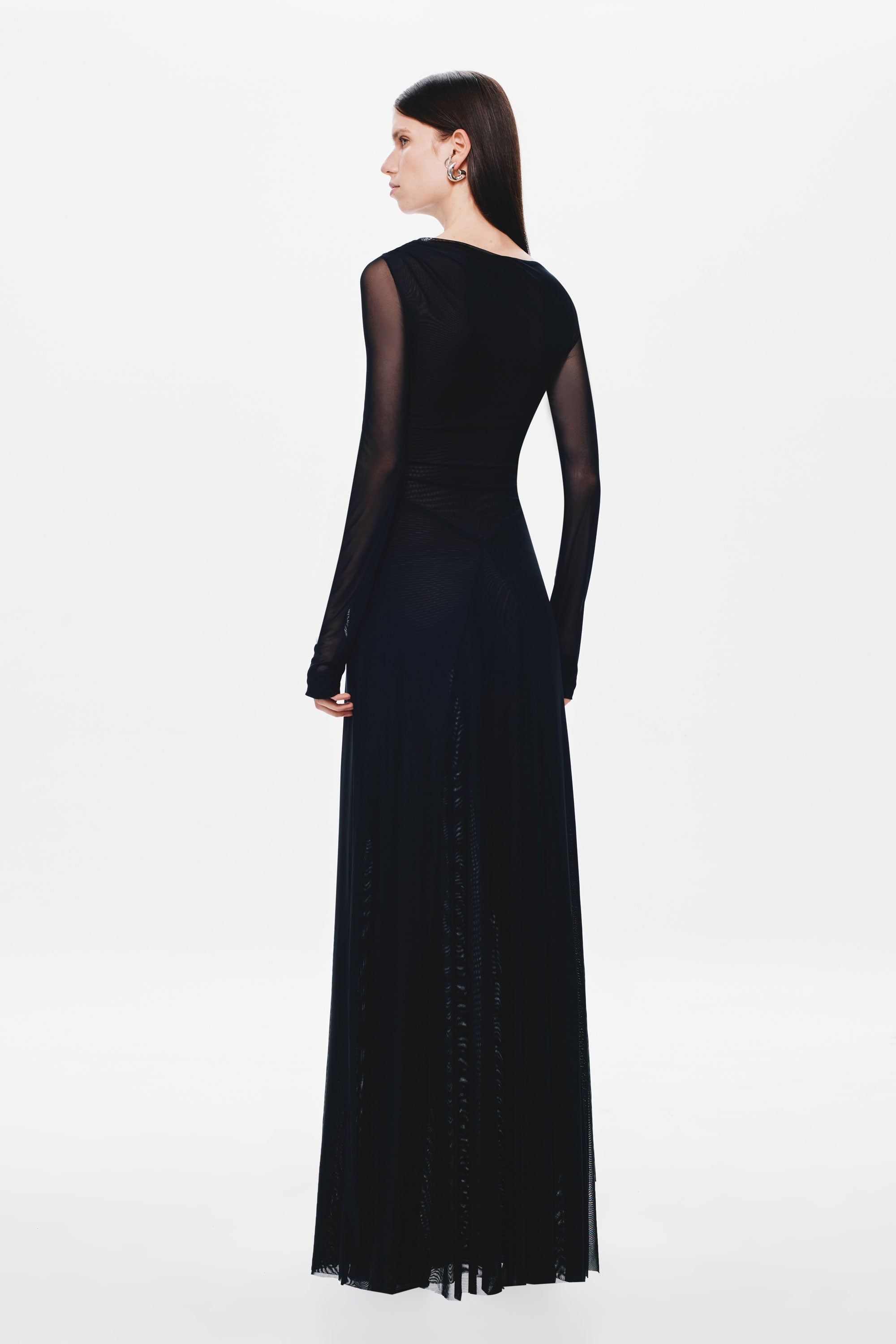 Black long-sleeve maxi dress back view with sheer upper back panel and drape