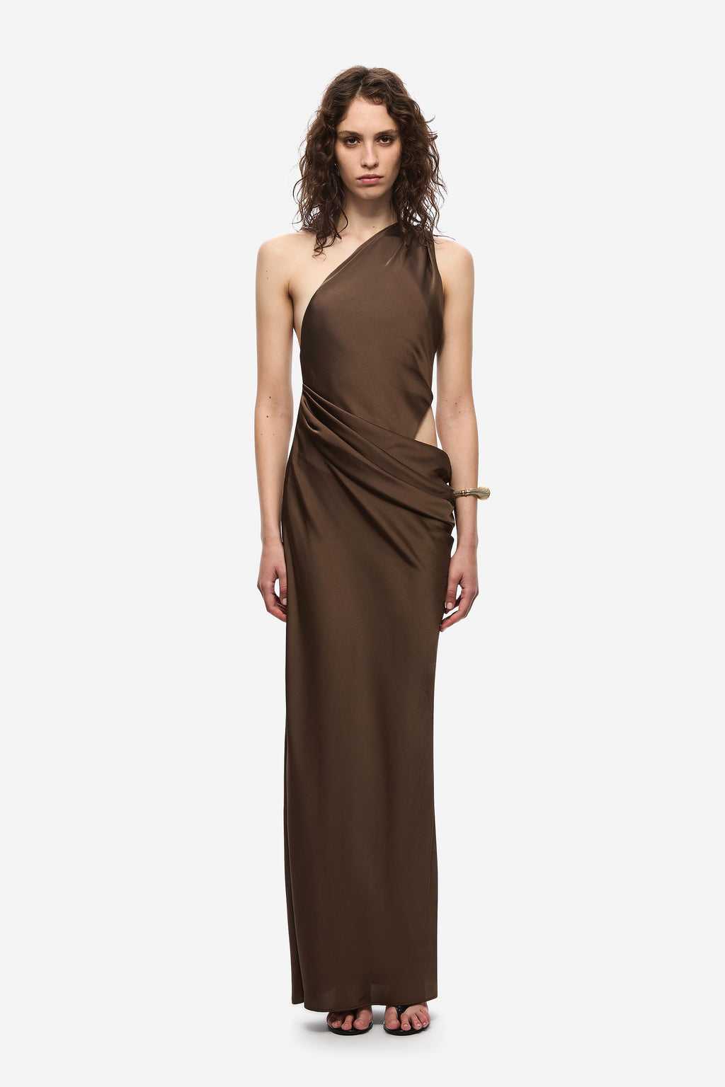 Brown satin halter dress with draped one-shoulder neckline and long column silhouette
