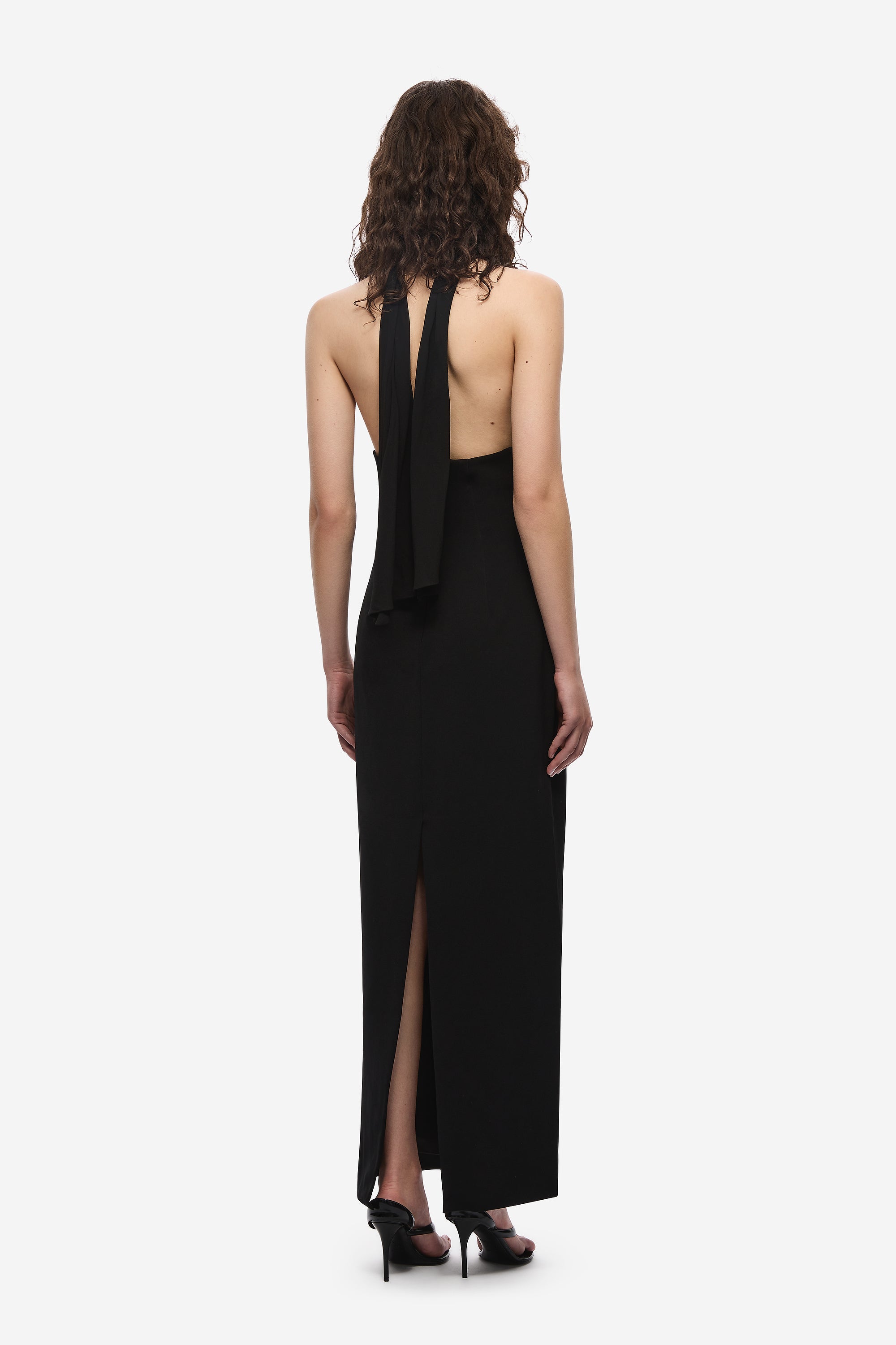 Black halter silk dress with open back and long column silhouette