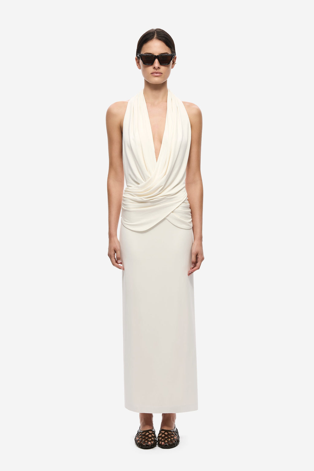 Ivory sleeveless halter dress with draped surplice neckline and ruched waist