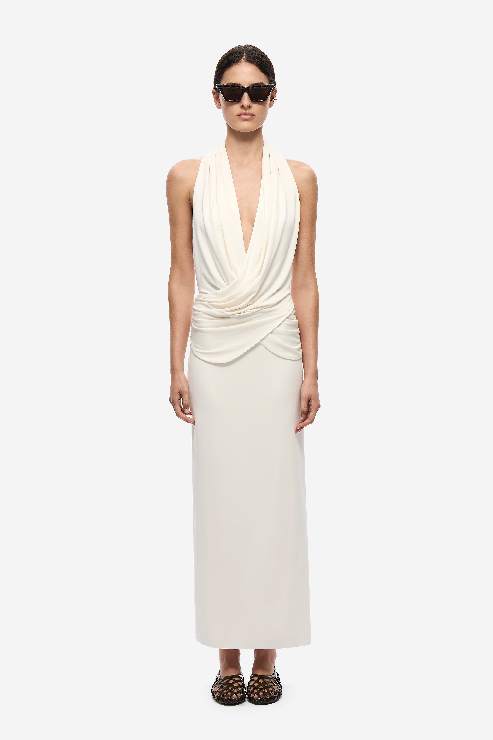 Ivory sleeveless halter dress with draped surplice neckline and ruched waist