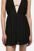 Front view of black mini dress with halter straps and ruched pleated bodice