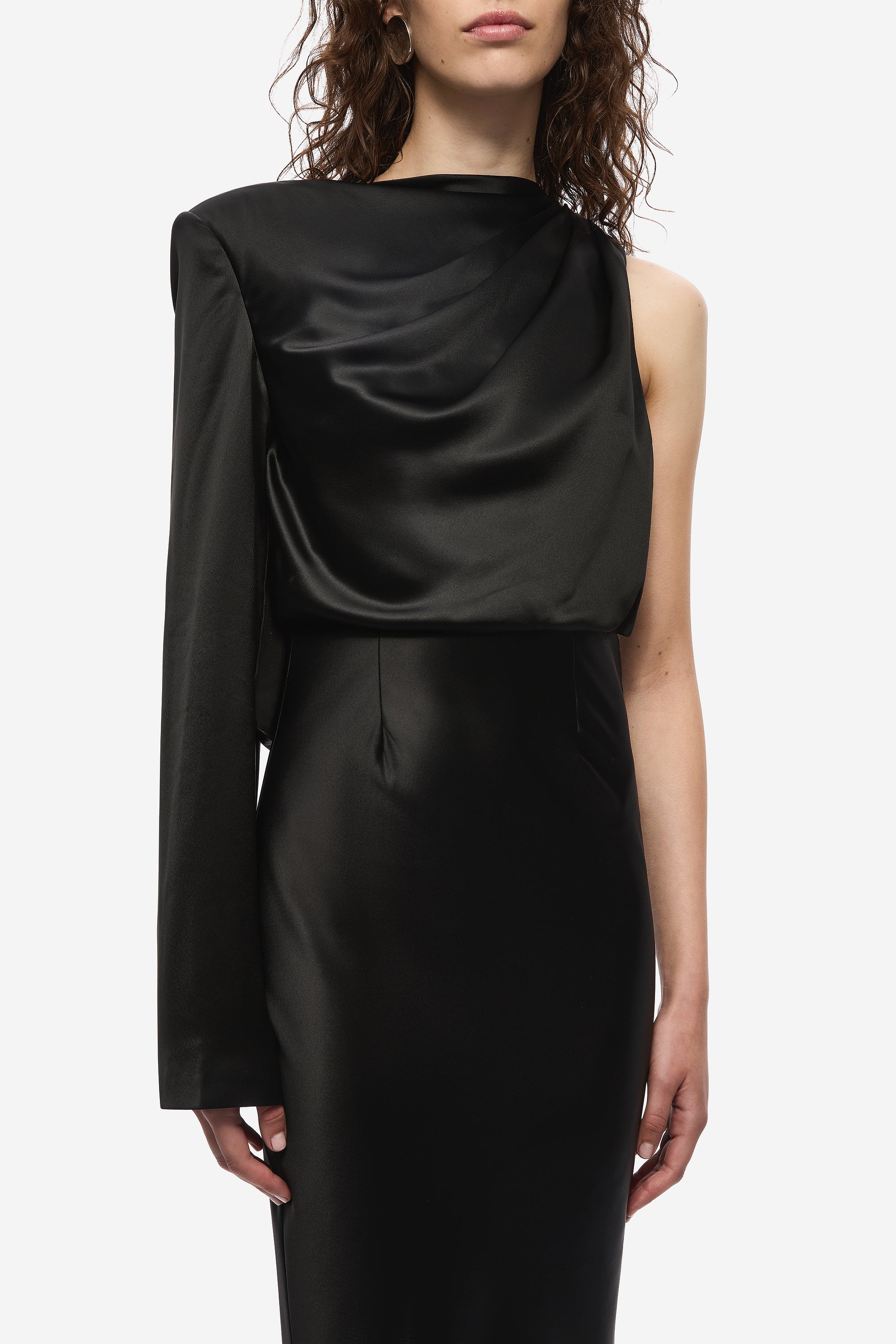 Black satin midi dress close-up: draped cowl neckline on sleeveless bodice