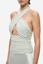 Pistachio halter midi dress close-up: ruched crossover drape at bodice