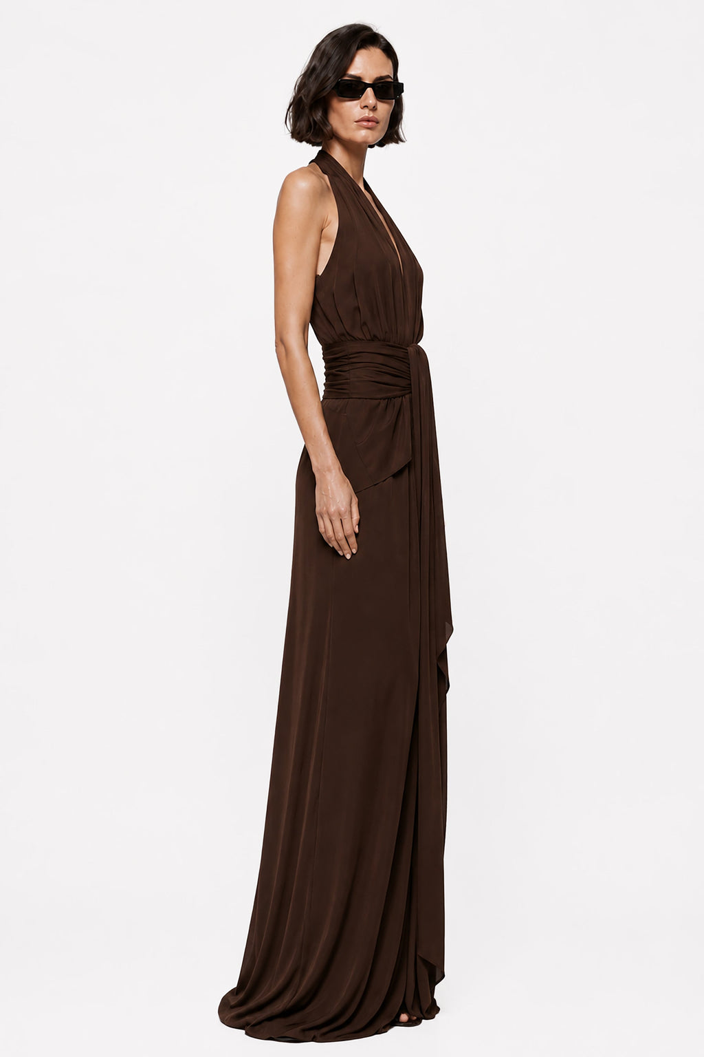 Chocolate sleeveless halter gown with draped waist and wrap skirt, full length