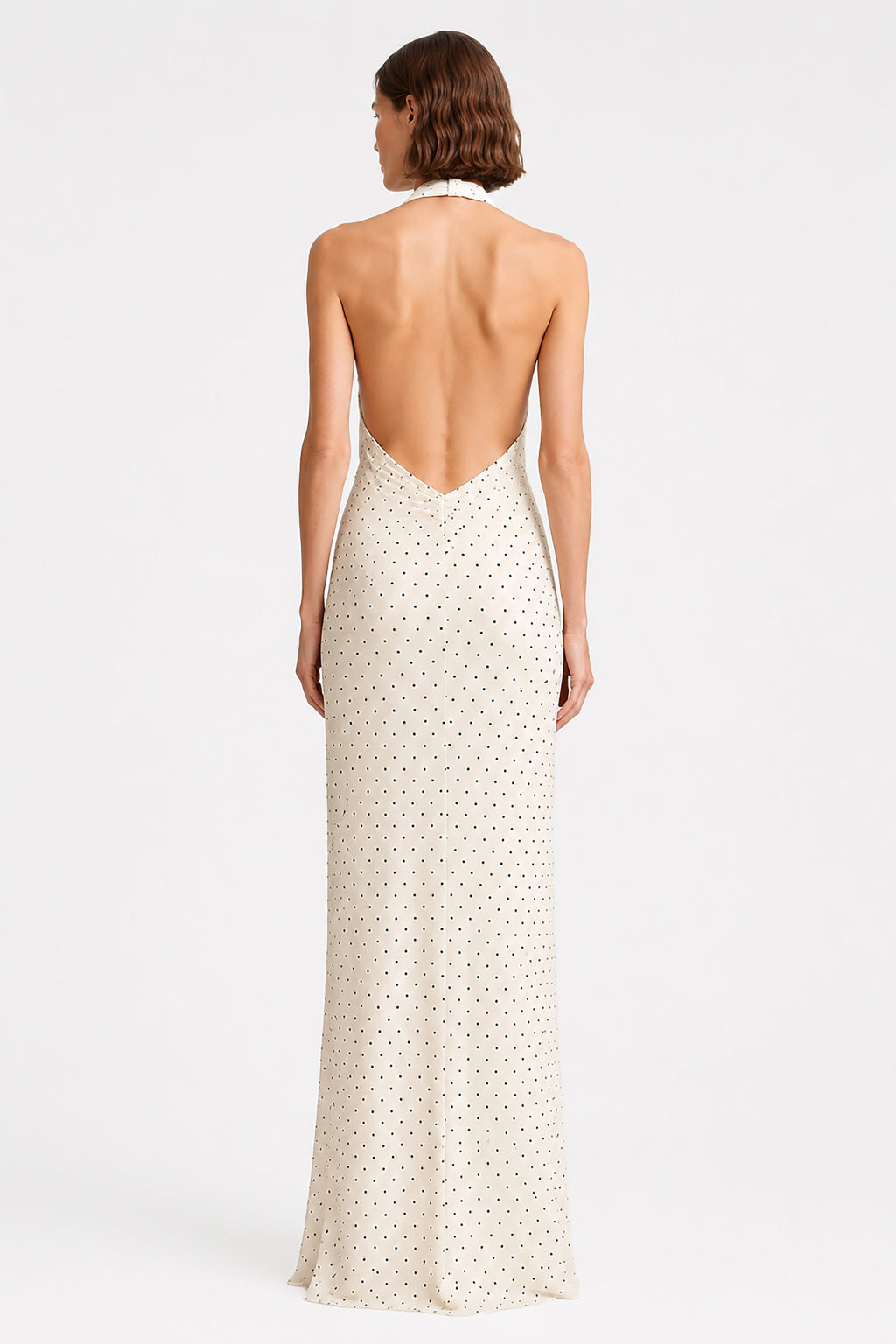Ivory sleeveless maxi dress with open back and tiny dot print, back view.