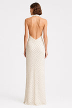 Ivory sleeveless maxi dress with open back and tiny dot print, back view.