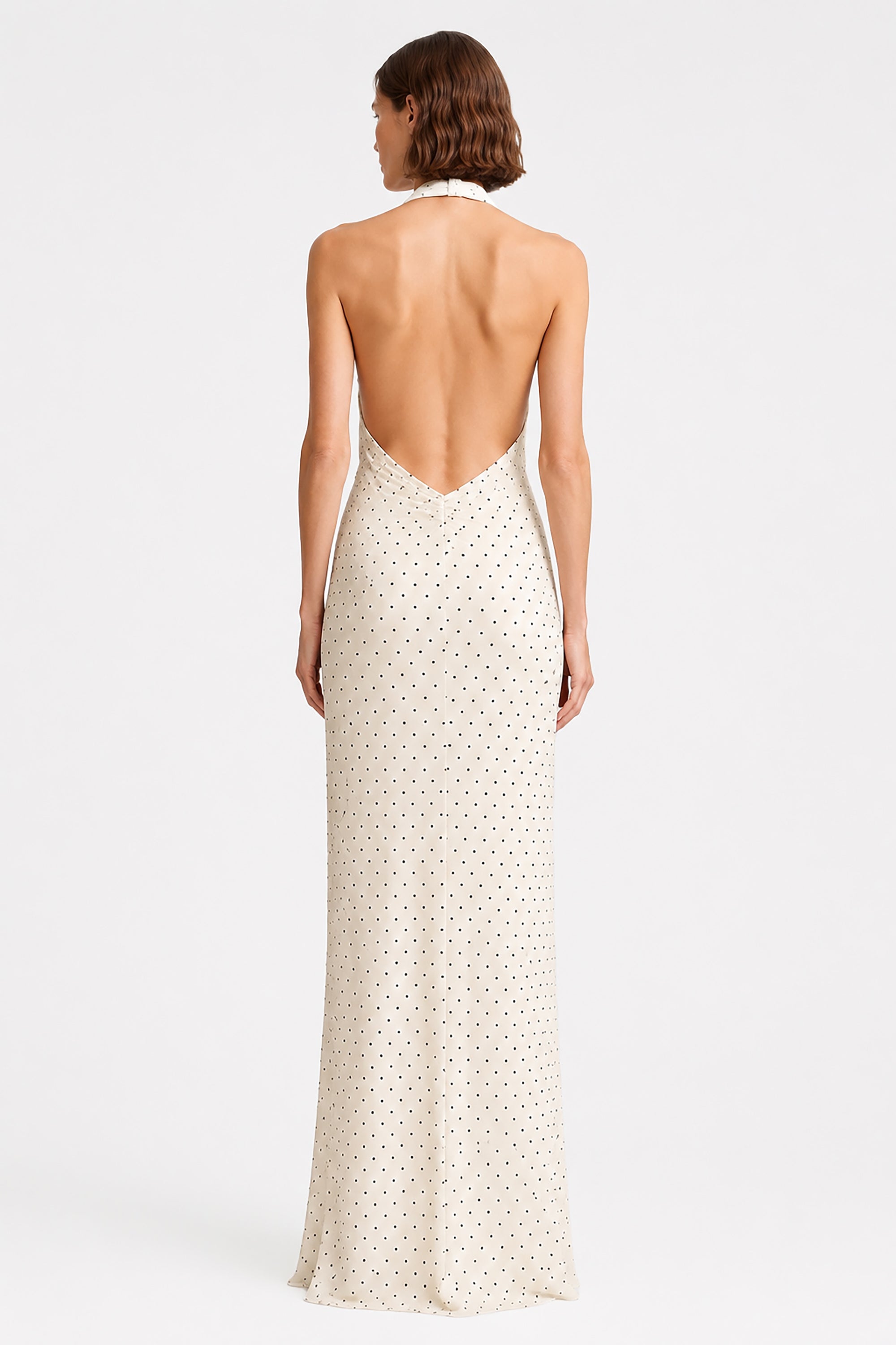Ivory sleeveless maxi dress with open back and tiny dot print, back view.