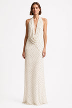 Ivory sleeveless maxi dress with V-neck and allover tiny dot print, draped front.
