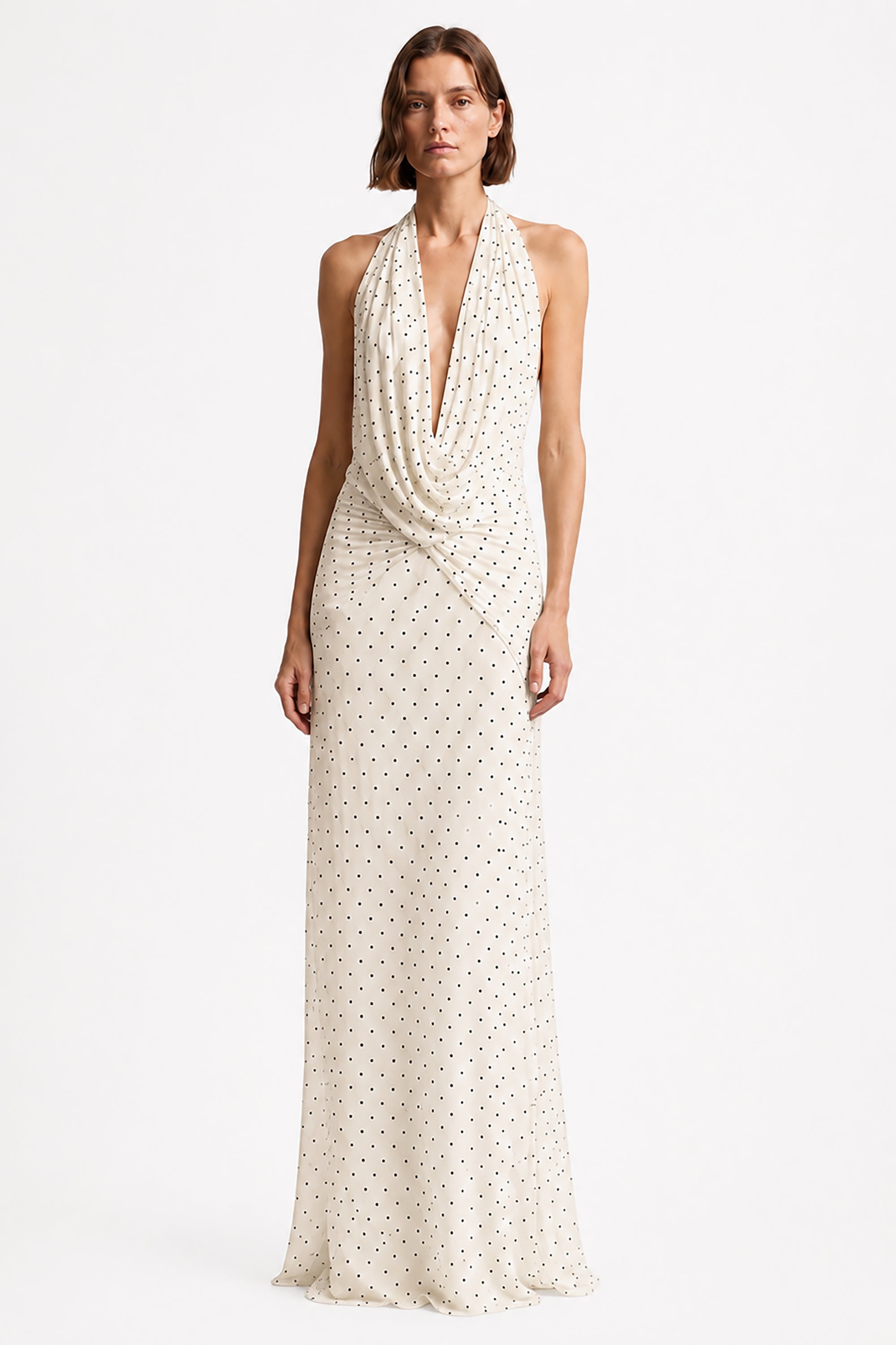 Ivory sleeveless maxi dress with V-neck and allover tiny dot print, draped front.