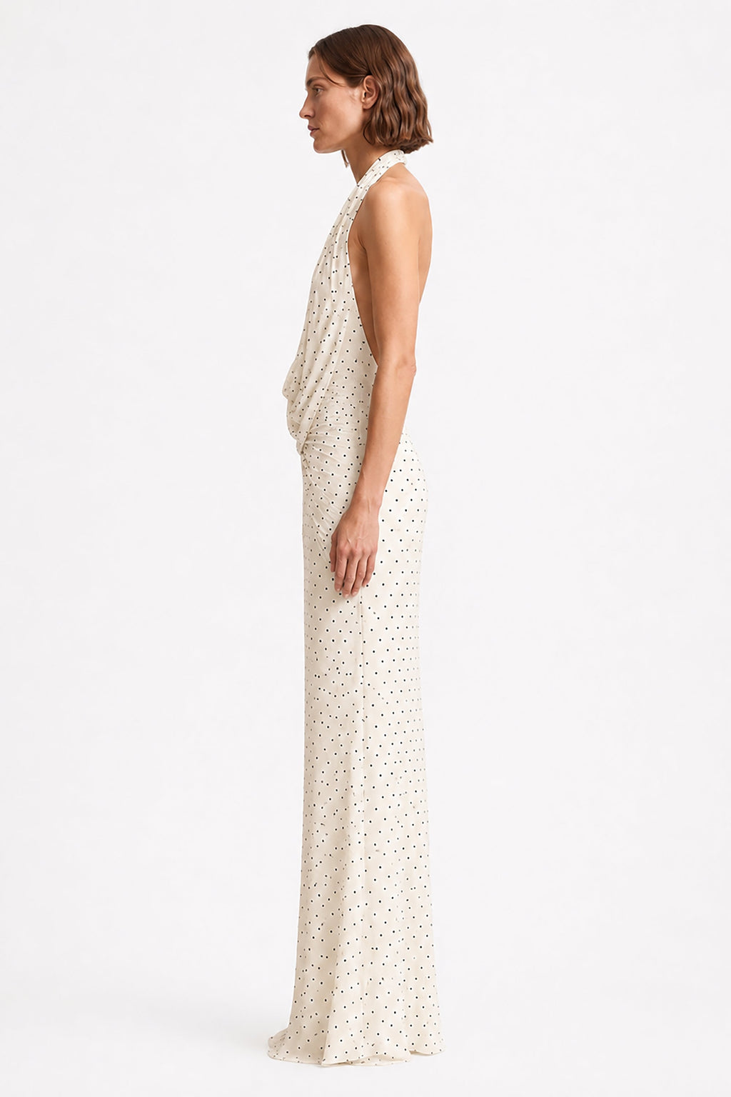 Ivory sleeveless maxi dress with V-neck and tiny dot print, side view.