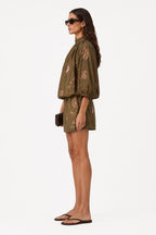 Olive mini dress with high neck ruffle and long puff sleeves, side view, floral print