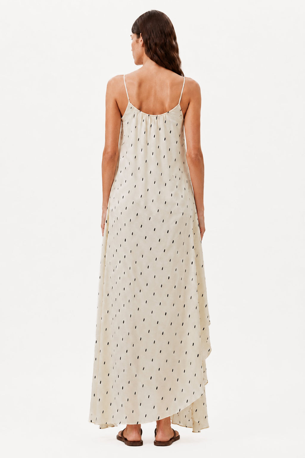 Ivory maxi dress back view with thin straps, draped hem, and small dot print