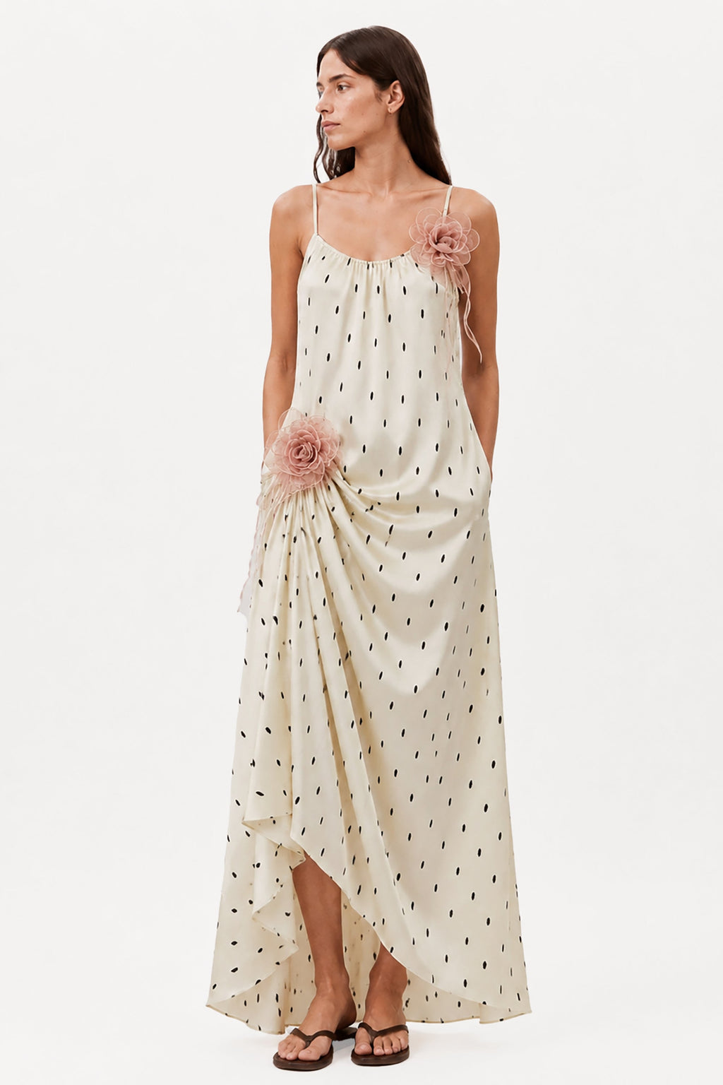 Ivory maxi dress with spaghetti straps, allover tiny print, and pink rosette details