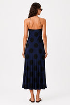 Navy polka dot midi dress back view with spaghetti straps and bias cut flared hem