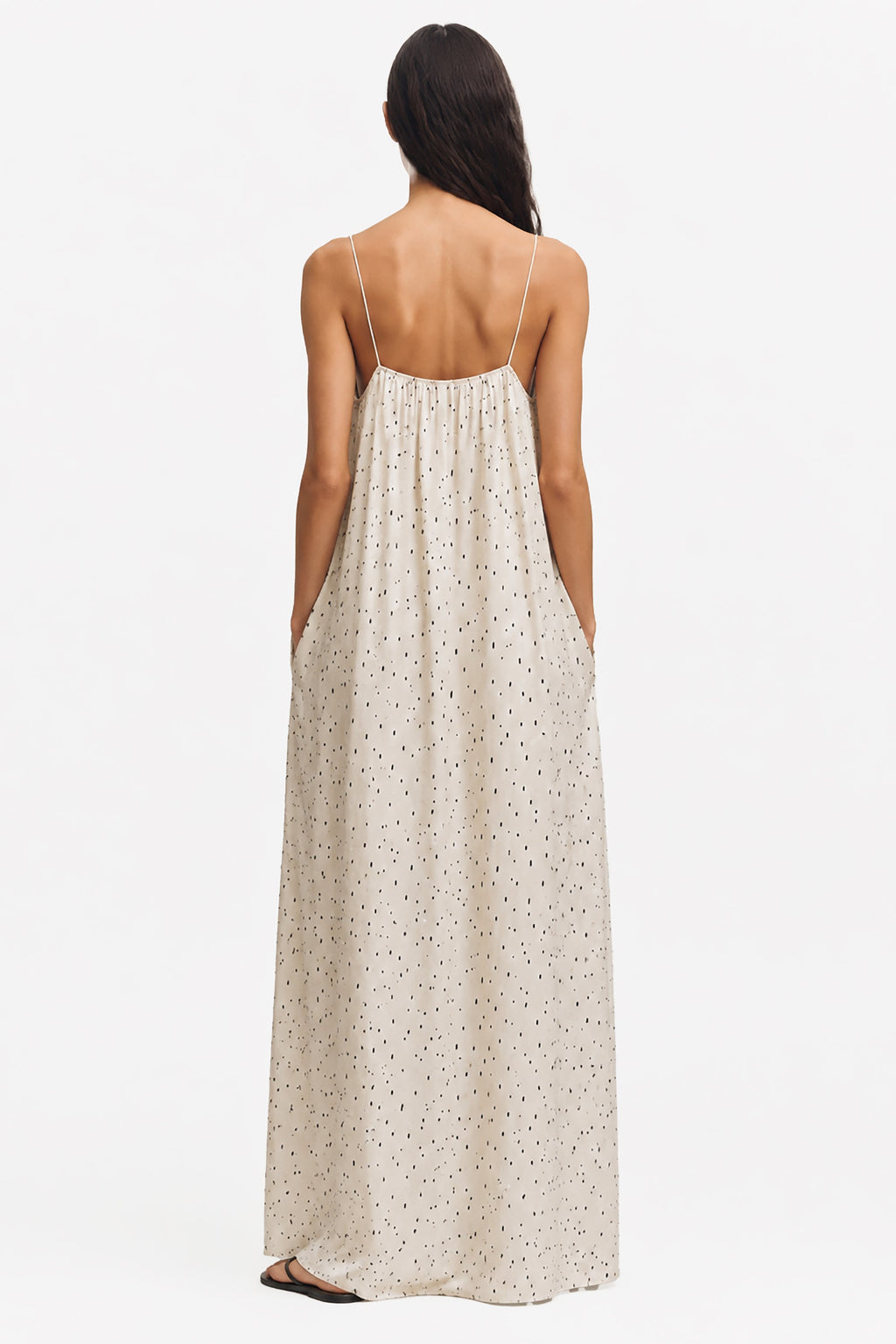 Ivory printed maxi trapeze dress, back view; open-back straps and speckled dotted print