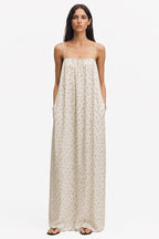 Ivory printed maxi trapeze dress with spaghetti straps and dotted speckle pattern