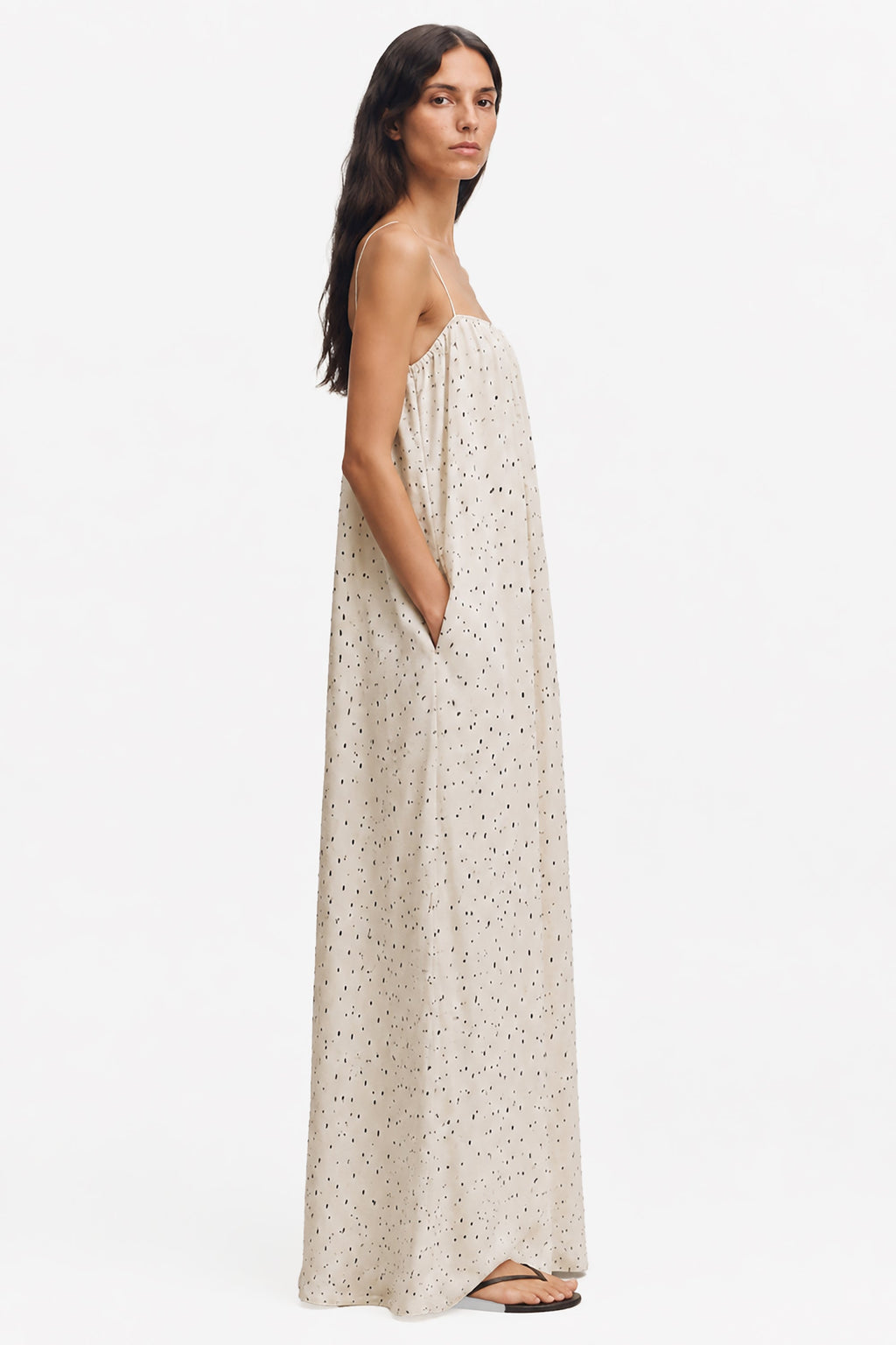 Ivory printed maxi trapeze dress, side view; thin spaghetti straps and speckled dots