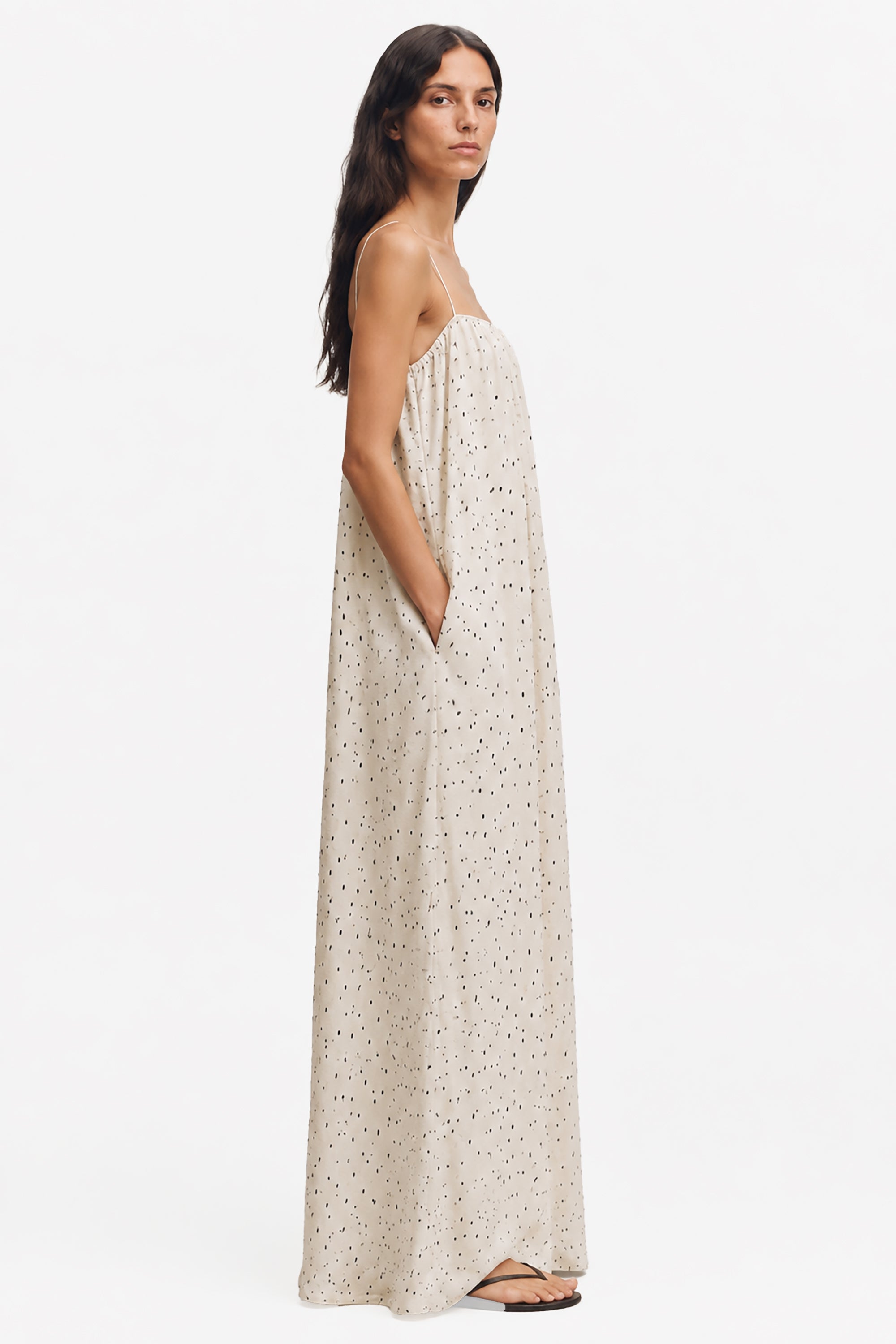 Ivory printed maxi trapeze dress, side view; thin spaghetti straps and speckled dots