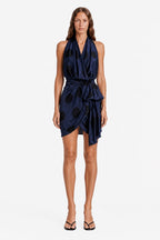 Navy polka dot wrap mini dress with sleeveless V-neck and tied waist