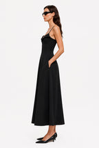 Black midi crepe dress with thin straps and fitted waist, side view