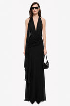 Black sleeveless maxi dress with deep V halter neckline and ruched drape waist