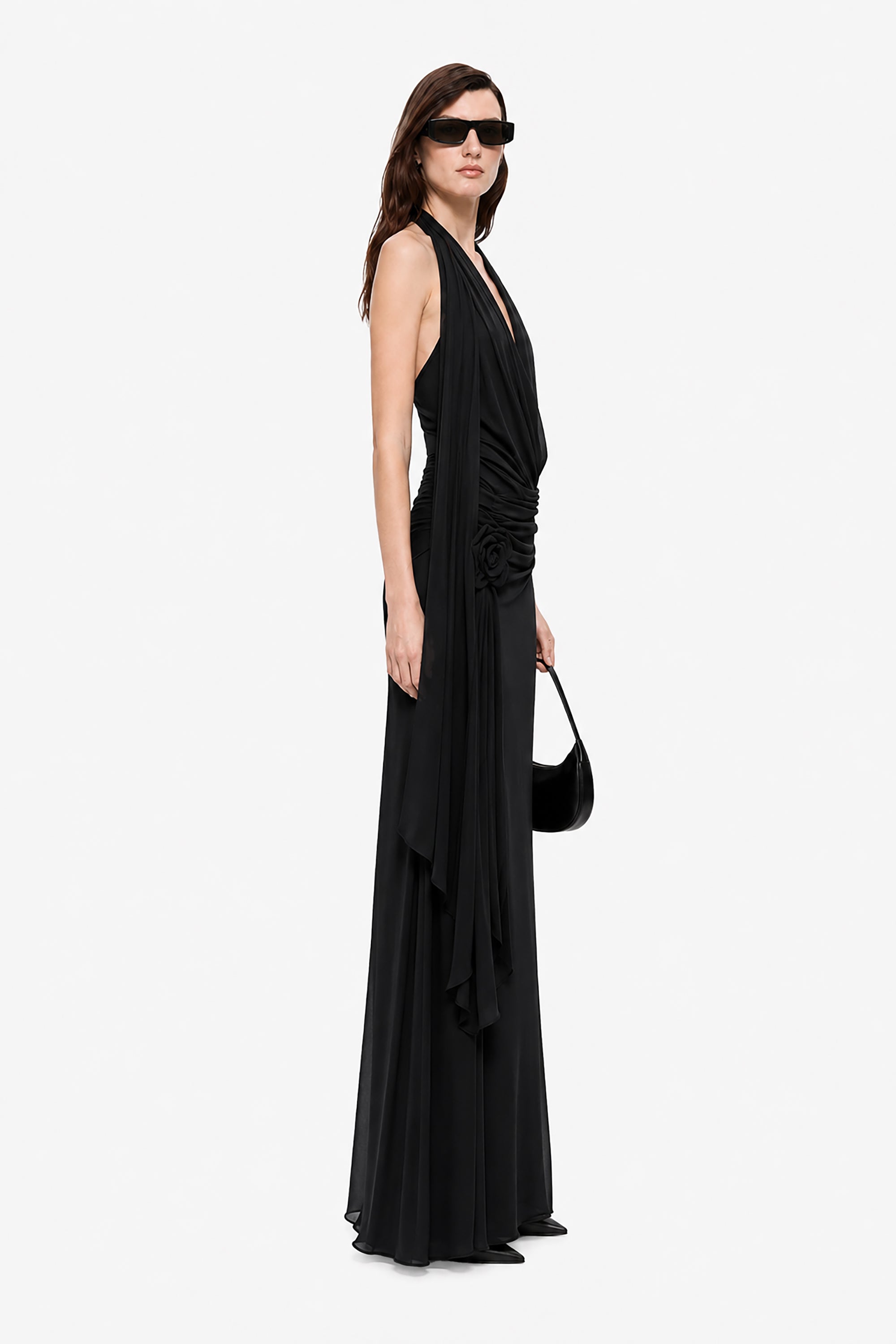 Black sleeveless maxi dress with draped crossover bodice and layered skirt
