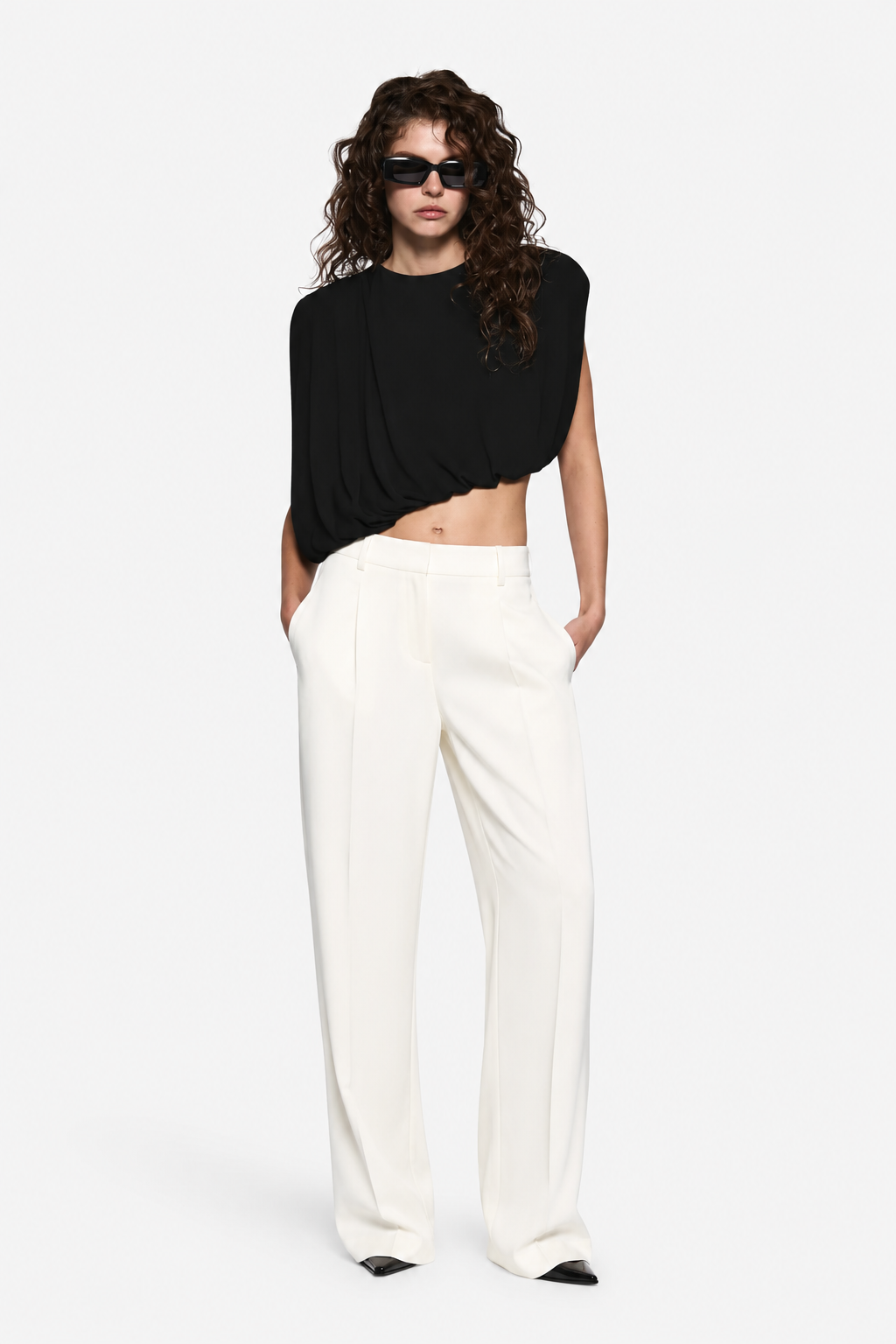 Black draped jersey top with pleated neckline and loose asymmetrical hem