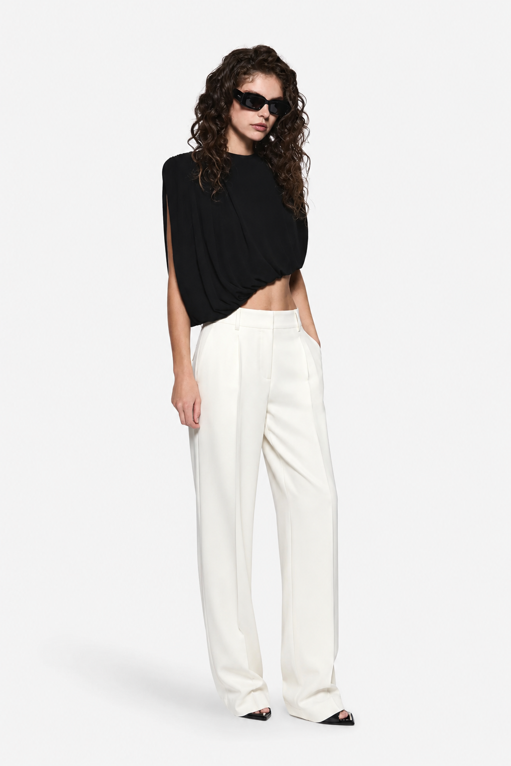Black sleeveless draped jersey top with gathered front and draped side