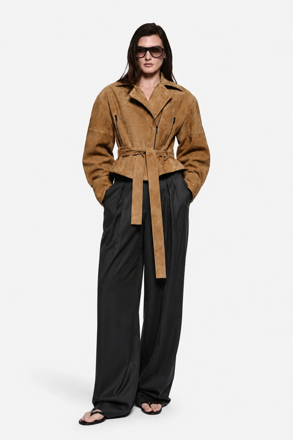 Tan suede leather jacket with belt tie at waist, notched collar, and zipper front