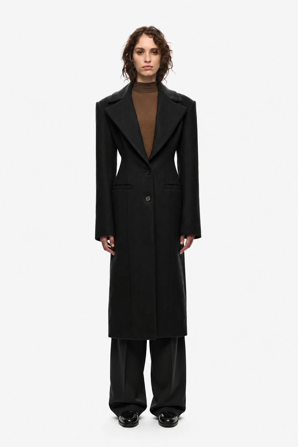 Black long coat with notched lapels, button front, and belted waist