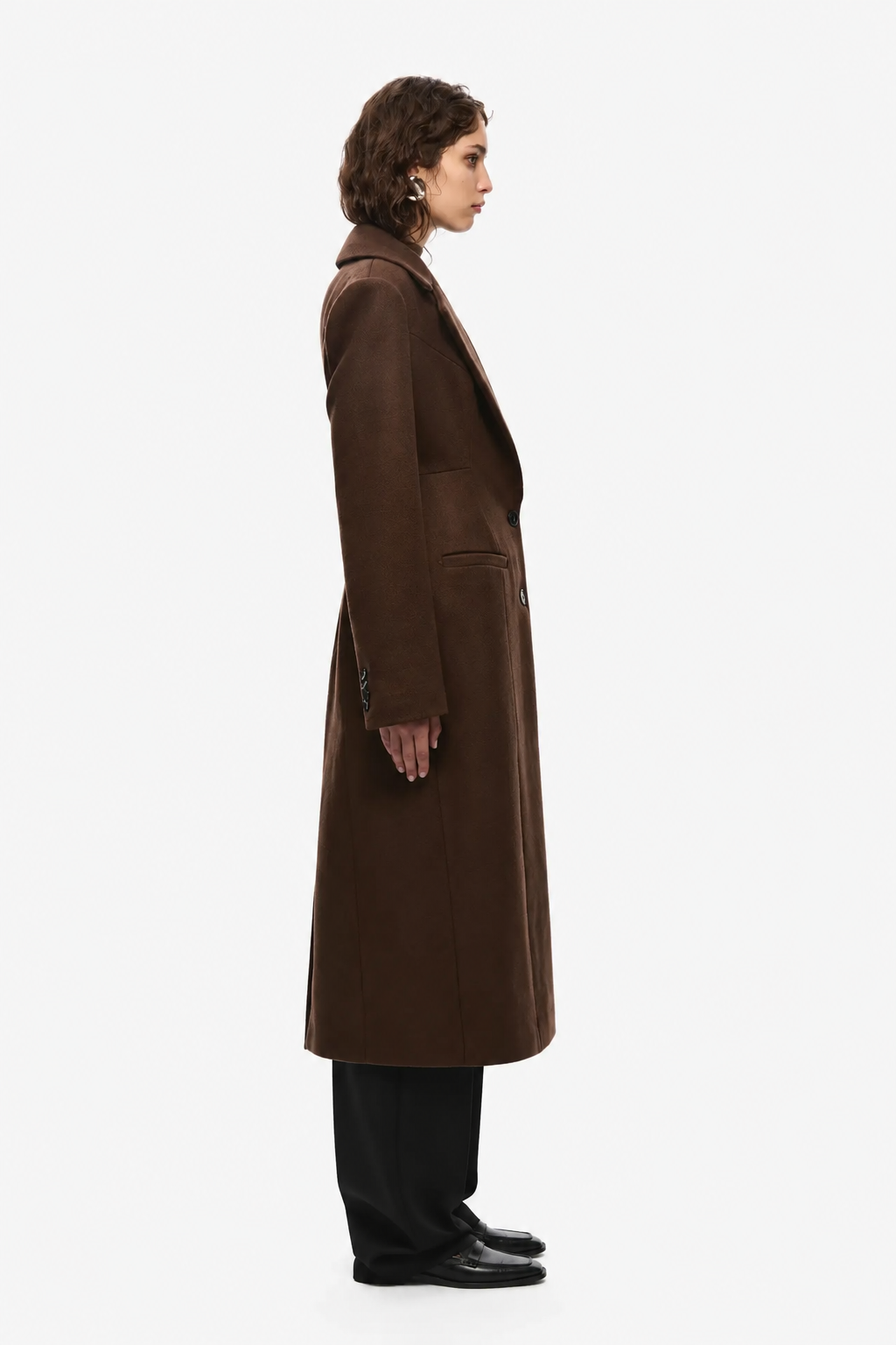 Brown tailored wool long coat, side profile with tailored sleeve and button detail