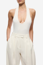 Ivory pleated barrel-leg trousers with high-rise waistband and pressed front pleats