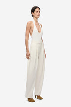 Ivory halter knit bodysuit with deep scoop neckline, sleeveless, side view