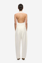 Ivory pleated barrel-leg trousers, back view with high waist and wide legs
