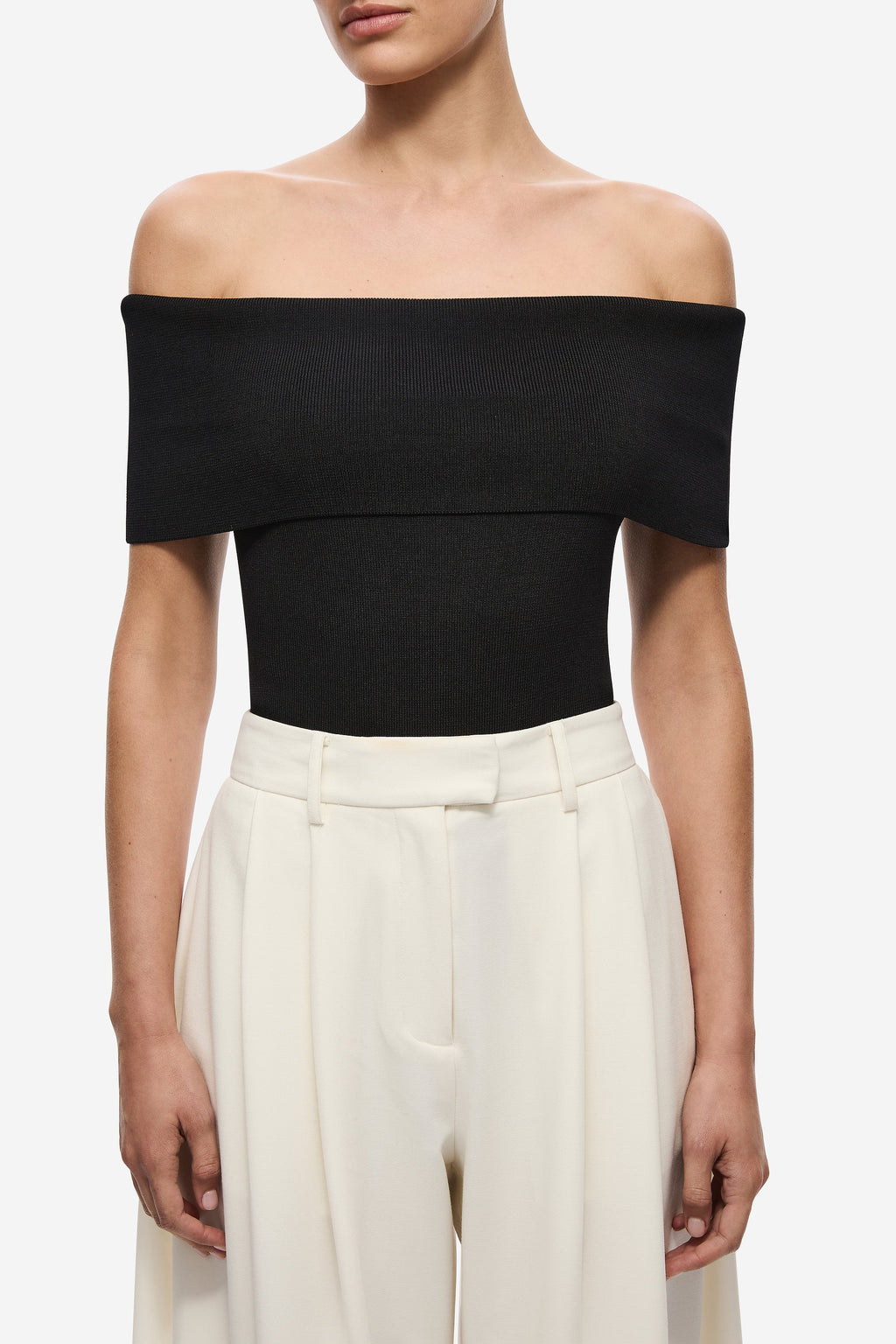 Black off-shoulder knit bodysuit, fitted bodice and high-cut leg