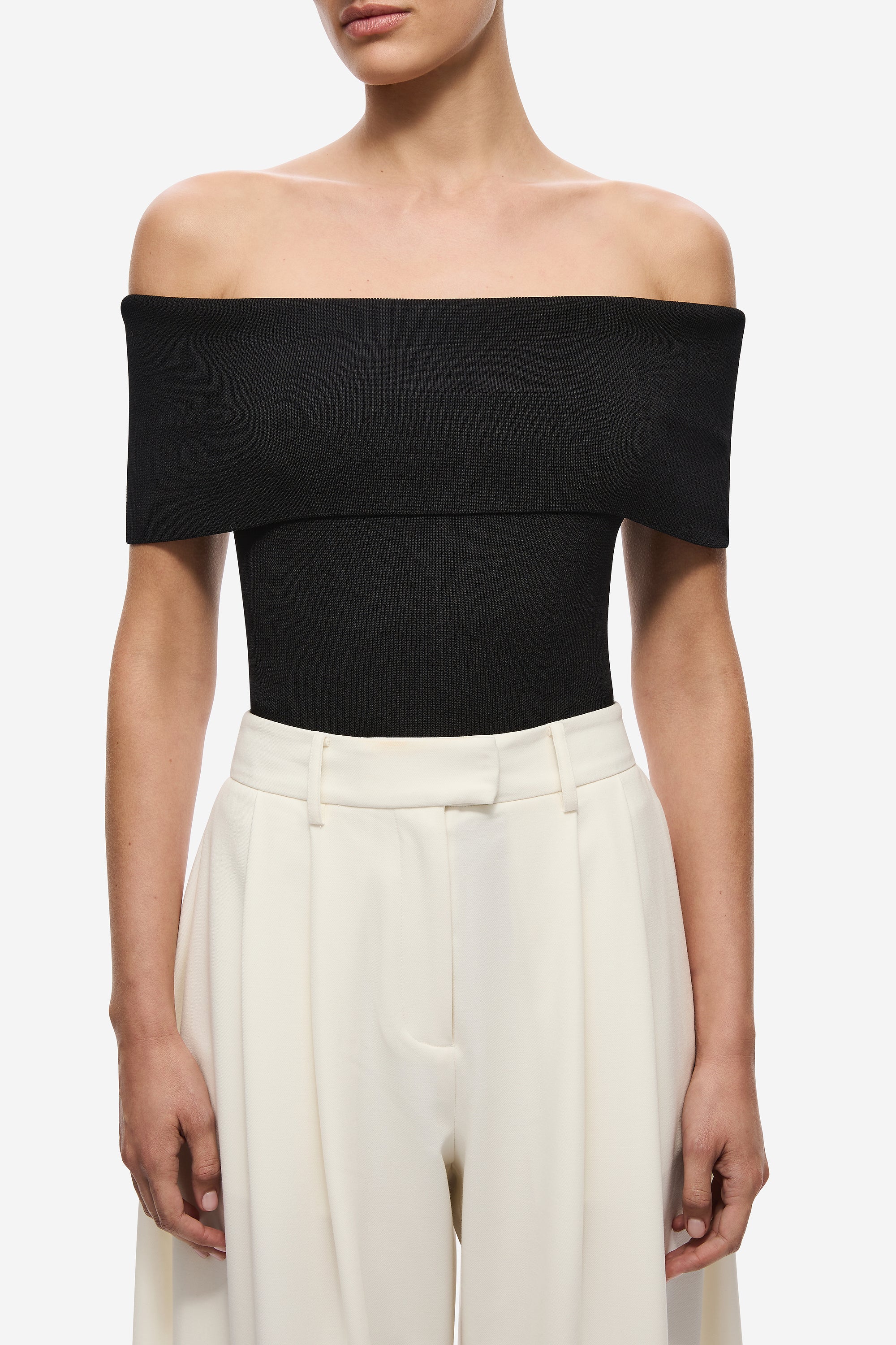 Black off-shoulder knit bodysuit, fitted bodice and high-cut leg