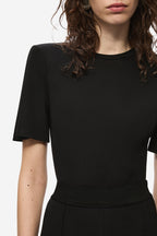Black stretch crepe trousers waistband close-up, seamless fitted waist