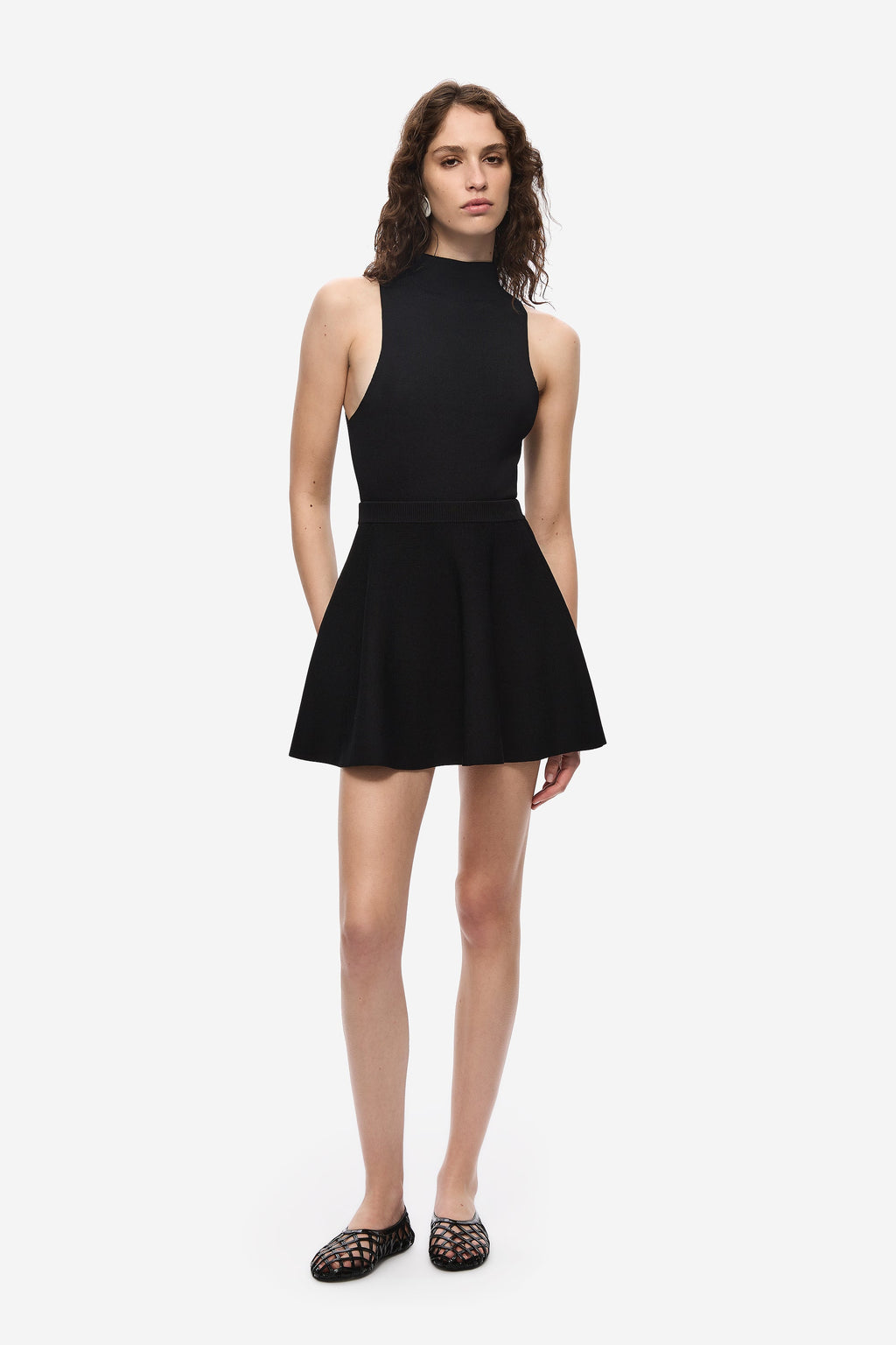 Black flared knit mini skirt, A-line silhouette with fitted waistband