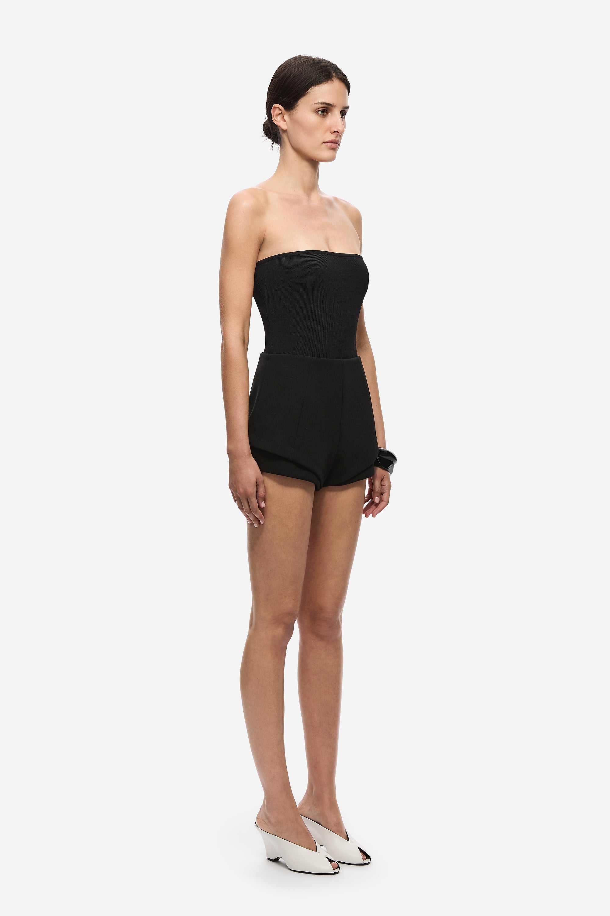Black strapless knit bodysuit, side view with high-waist shorts