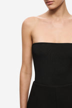 Black strapless knit bodysuit close-up of ribbed neckline and waist seam