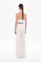 Off-white halter silk top with open back and V-shaped back neckline