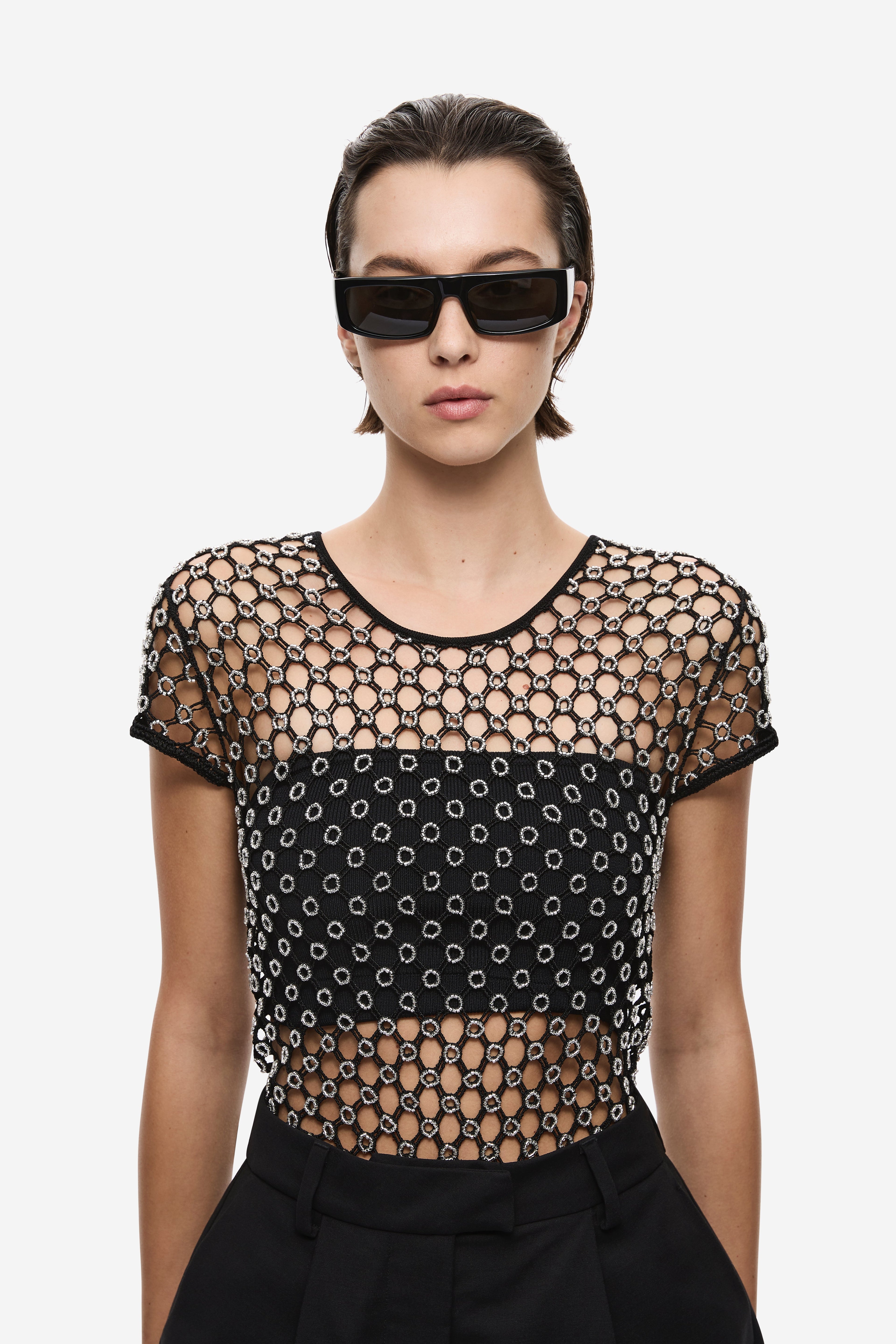 Black beaded crochet cropped tee close-up, round neck, chain-and-dot pattern.