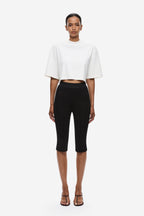 Black crepe capri pants with mid-rise waist, slim fit, ankle-length hem