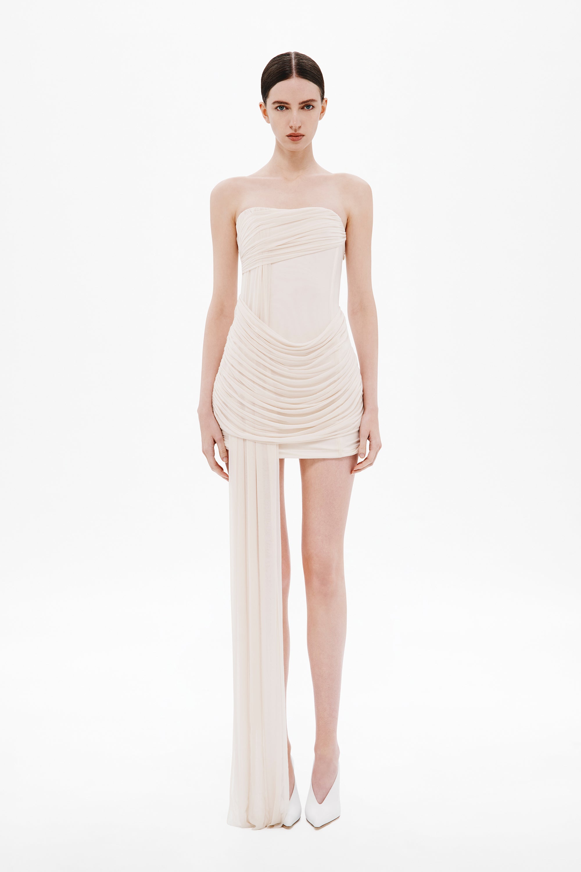 Strapless wrapped mini dress in whisper white with ruched draping and thigh slit