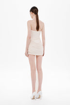 Back view strapless mini dress in whisper white with ruched wrap seams and short hem