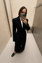 Black long coat with wide lapels and single-breasted button front