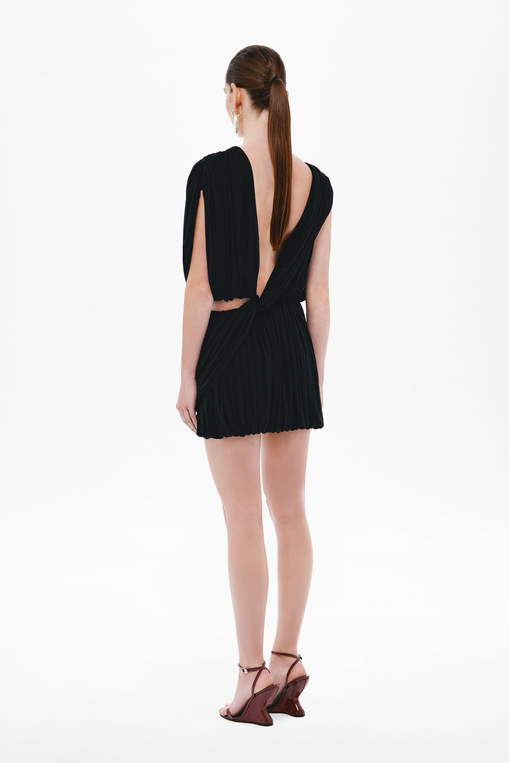 Black jersey mini dress with open V back and pleated gathered design