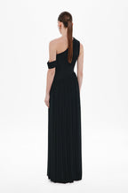 Black one-shoulder maxi dress shown from back, sleeveless with pleated column skirt