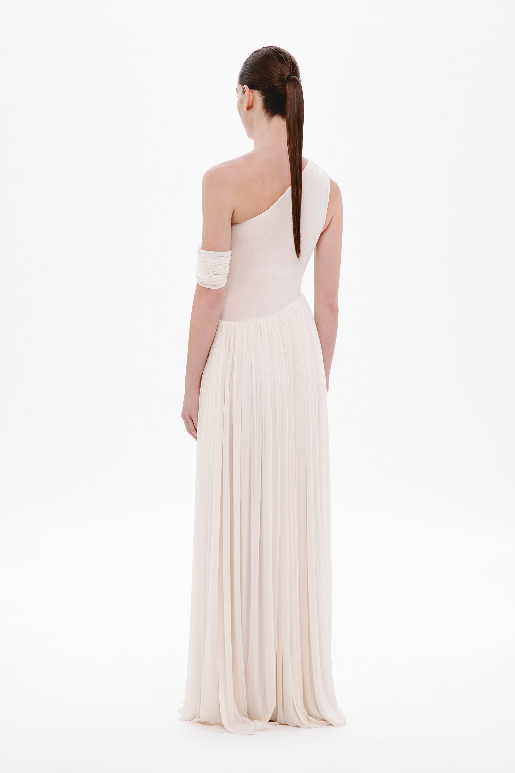 Whisper white backless one-shoulder maxi dress with draped strap and pleated skirt